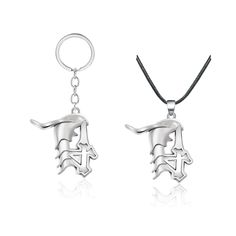 two silver necklaces with an image of a dog on it