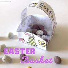 an easter basket filled with chocolate eggs on top of a white table next to other candies