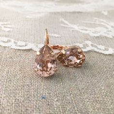 "Heatherly Designs signature teardrop short dangling lever back earrings made with genuine Swarovski® crystals in faux morganite and are set in plated brass. ●Nickel free ●Size (L x W): 1\" x 3/8\" or 23 x 10mm ●Swarovski crystal color(s): Vintage Rose ●Arrives in our signature Heatherly gift box. Handmade with ❤ by Heather ● ● ● ● ● ● ● ● ● ● ● ● ● ● ● ● ● ● ● ● ● ● ● ● ● ● ● ● →Quantity Discounts listed below: 10% off 3-6 pcs - 10OFF3TO6 15% off 7-9 pcs - 15OFF7TO9 20% off 10+ pcs - 20OFF10PLU Blush Pink Cushions, Cushion Earrings, Crystal Teardrop Earrings, Rose Gold Morganite, Pink Swarovski, Box Handmade, Leverback Earrings, Swarovski Crystal Earrings, Wedding Jewelry Earrings