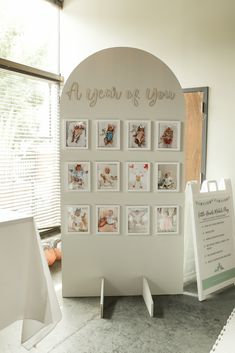 a white display with pictures on it in front of a sign that says at years of you