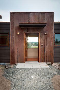 the entrance to a modern home with wood siding