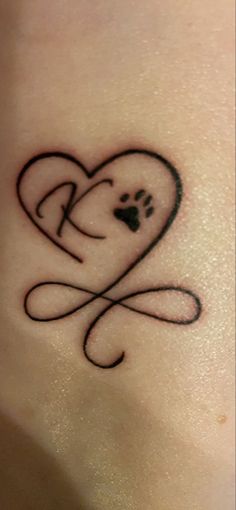 a small heart tattoo with a dog's paw in the shape of a heart