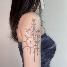 a woman with a tattoo on her arm