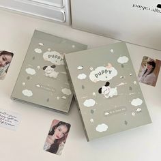 two books with pictures on them sitting next to a computer keyboard and mouse, which are also decorated with polaroid stickers