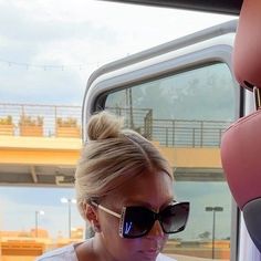 a woman in sunglasses looking at her cell phone