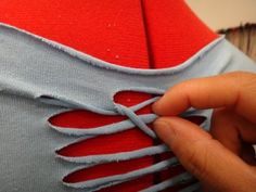 someone is stitching the side of a dress