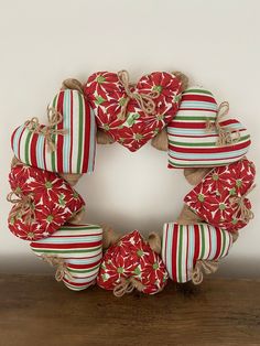 a wreath made out of burlocks and twine on top of a wooden table