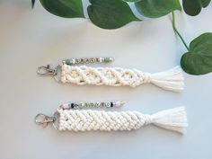 two crocheted key chains sitting next to each other on top of a table