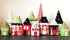 a group of small christmas houses sitting on top of a table