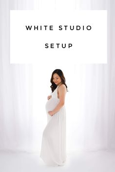 a pregnant woman standing in front of a white backdrop with the words, white studio setup