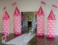 some pink balloons are in the shape of towers