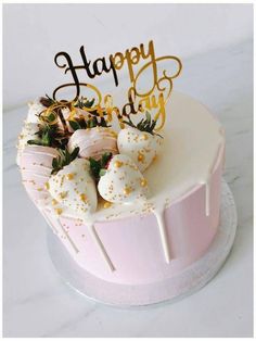 a birthday cake with white frosting and gold sprinkles on the top