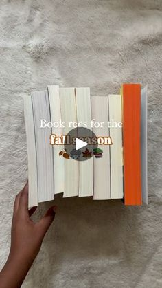 someone is holding an open book with the words books for the fall season on it