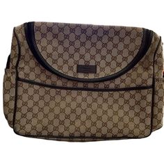 a brown and black bag with the word gucci on it's front flap