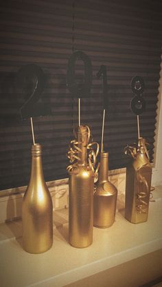 three gold vases are sitting on a window sill with the number twenty one