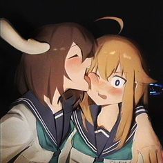 two anime characters are kissing each other with horns on their heads in front of them