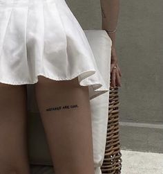 the back of a woman's legs with writing on them