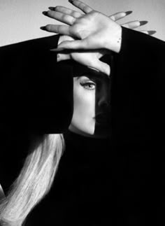 a woman with long blonde hair covering her face