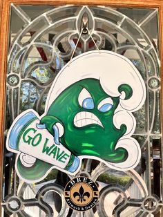 a glass window with a green cartoon character on it