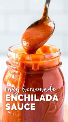 an easy homemade enchilada sauce in a jar with a spoon sticking out