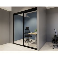 an office cubicle with glass walls and a desk in the corner, along with chairs