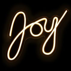 the word joy written in neon lights on a black background with an orange and yellow glow