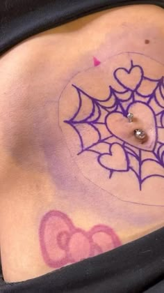 a woman with a spider web tattoo on her stomach