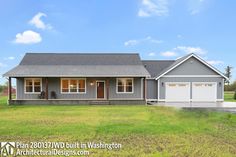 a gray house with two garages in the front yard and grass on both sides