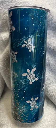 a blue tumbler with sea turtles on it