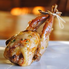 two cooked meats on a plate with string wrapped around the top and bottom end