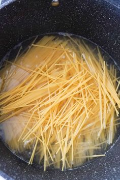 pasta is being cooked in a pot on the stove