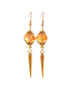 These gorgeous statement earrings are both elegant and edgy! Amber glass faceted beads along with gold tones give these spike dangle earrings a chic look! Earrings are also lightweight making them very wearable! Earring hooks are 22k gold plated hypoallergenic and will help to avoid irritating the ears. Clip ons also available! Product Details .Amber glass faceted beads. .Antique gold plated metal alloy spikes. .Antique gold plated bead caps. .22k gold plated head pins & jump rings. .22k gold plated hypoallergenic earring hooks. .Gold plated steel earring clips. Length Of Earrings Including Hooks - 3¼ inches. All items are shipped in a beautiful gold and teal packaging, ready for gifting! Metal Earrings With Faceted Beads For Party, Gold Drop Earrings With Faceted Beads, Gold Faceted Crystal Earrings For Party, Gold Crystal Earrings With Faceted Beads, Gold Faceted Bead Drop Earrings, Glamorous Gold Dangle Clip-on Earrings, Gold Beaded Drop Clip-on Earrings, Antique Gold Dangle Clip-on Earrings, Yellow Gold Dangle Clip-on Earrings In Brass