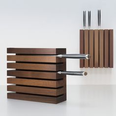 a knife holder with three knives in it and two on the other side, standing next to each other