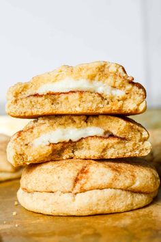 three cookies stacked on top of each other with icing and bananas in the background