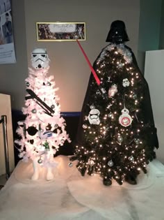 two star wars themed christmas trees are on display