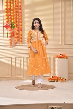 Description: Fabric:  Cotton Length: 46 inches Neck: Round shape Sleeves: 3/4th Sleeves  Color: Mustard Yellow Embroidery: Ghass Patti Thread:  White Cotton Touch and Feel: Smooth and soft.  Silhouette: This Cotton chikan kurti has a A long finish along with straight hems and side pockets. This is readymade prewashed kurti. The back and sleeves of the kurti are decorated with loosely scattered motifs. While the front of the chikankari kurti is enhanced with dense embroidered neck and motifs are Orange Straight Kurta With Chikankari Embroidery, Orange Cotton Kurta With Resham Embroidery, Orange Cotton Traditional Wear With Zari Work, Orange Cotton Kurta With Zari Work, Orange Bollywood Kurta With Chikankari Embroidery, Embroidered Cotton Kurta In Orange, Embroidered Cotton Orange Kurta, Embroidered Orange Cotton Kurta, Orange Chikankari Embroidery Kurta For Diwali