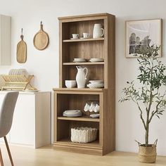 an open bookcase in the corner of a room with plates and cups on it