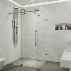 a bathroom with a toilet, sink and shower stall in the middle of the room