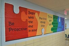 a classroom wall painted with colorful puzzle pieces