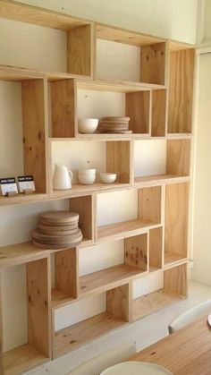 a wooden shelf filled with plates and bowls