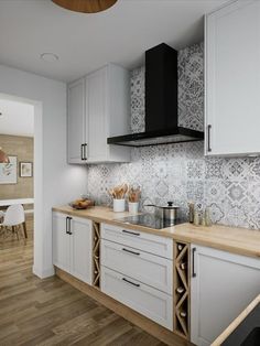 a kitchen with wooden floors and white cabinets