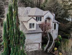 an aerial view of a house in the woods