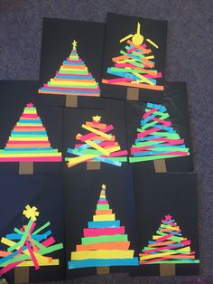 six christmas trees made out of construction paper with colored strips on the bottom and sides