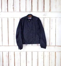 "90s black sporty wind breaker zipper jacket/athletic black track suit jacket/active wear/jogging jacket/Joe Rocket Features... -polyester construction accented with zippers -medium weight -black lining -zipper closure -Joe Rocket Measurements...taken flat -marked size: large -chest: 26\" (66 cm) -length: 25\" (63.5 cm) Condition... -excellent vintage condition -no flaws to note TAAA1234" Black Fitted Windbreaker For Sports, Fitted Black Windbreaker For Sports, Sporty Fitted Black Windbreaker, Casual Fitted Black Windbreaker, Fitted Casual Black Windbreaker, Vintage Black Windbreaker For Sports, Sporty Fitted Windbreaker With Pockets, Fitted Sporty Windbreaker With Pockets, Black Cotton Windbreaker For Sports