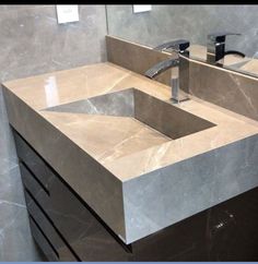 a bathroom sink sitting under a mirror next to a faucet