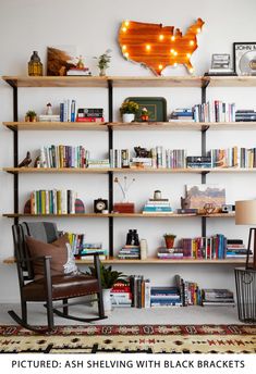 the room is filled with books and furniture