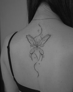 a woman with a butterfly tattoo on her back