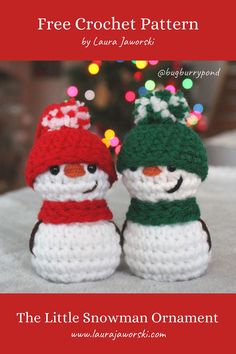 two crocheted snowmen sitting next to each other on top of a table