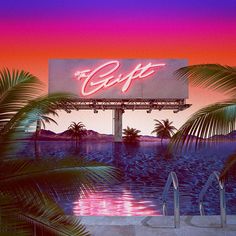 a billboard with the word cafe on it in front of palm trees and water at sunset