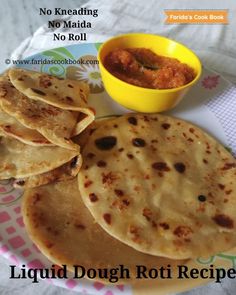 there are several flat breads on the plate and a bowl with sauce in it